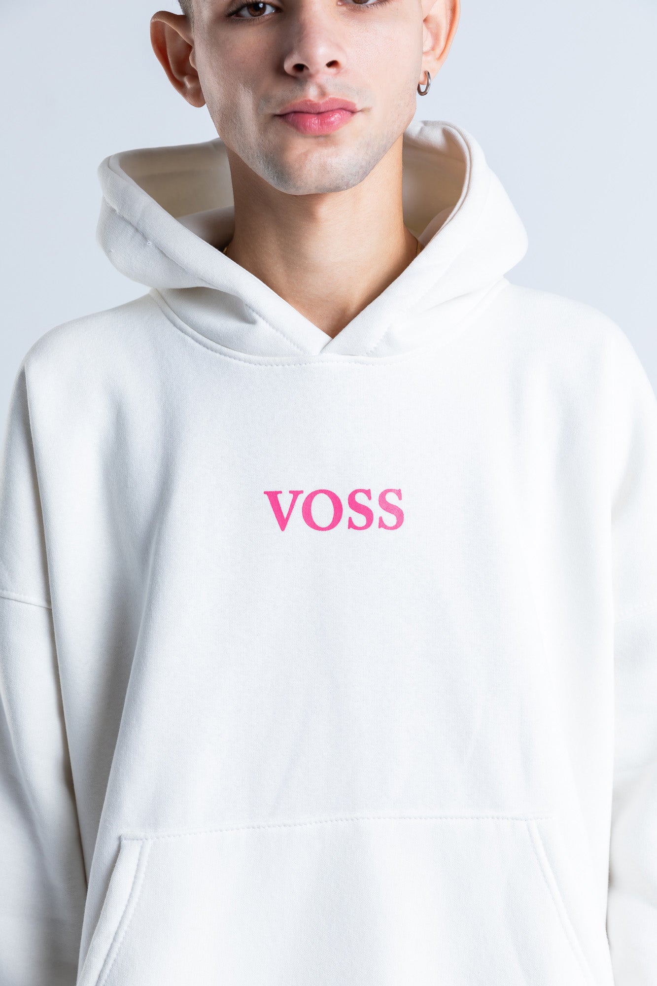Close-up of pink distortion hoodie showing graphic print details and the soft fabric texture for a stylish look.