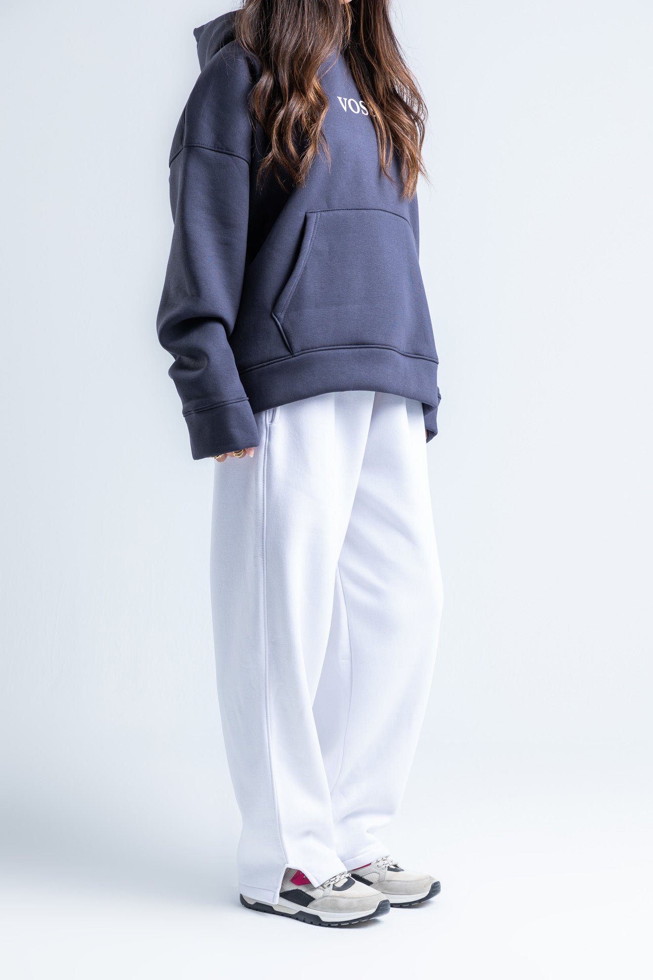 Side view of white wide-legged sweatpants highlighting the wide-leg silhouette and flowing design for everyday comfort.