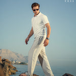 Men's white linen pants paired with a casual shirt, perfect for warm weather and versatile styling.