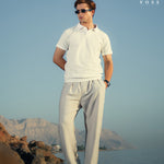 Front view of men's white linen pants with a straight-leg design, elastic waistband, and lightweight fabric for a relaxed fit.