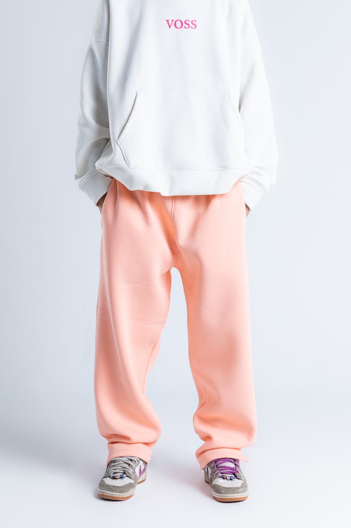 Front view of pink wide-legged sweatpants with an elastic waistband, soft fabric, and a relaxed fit for casual comfort