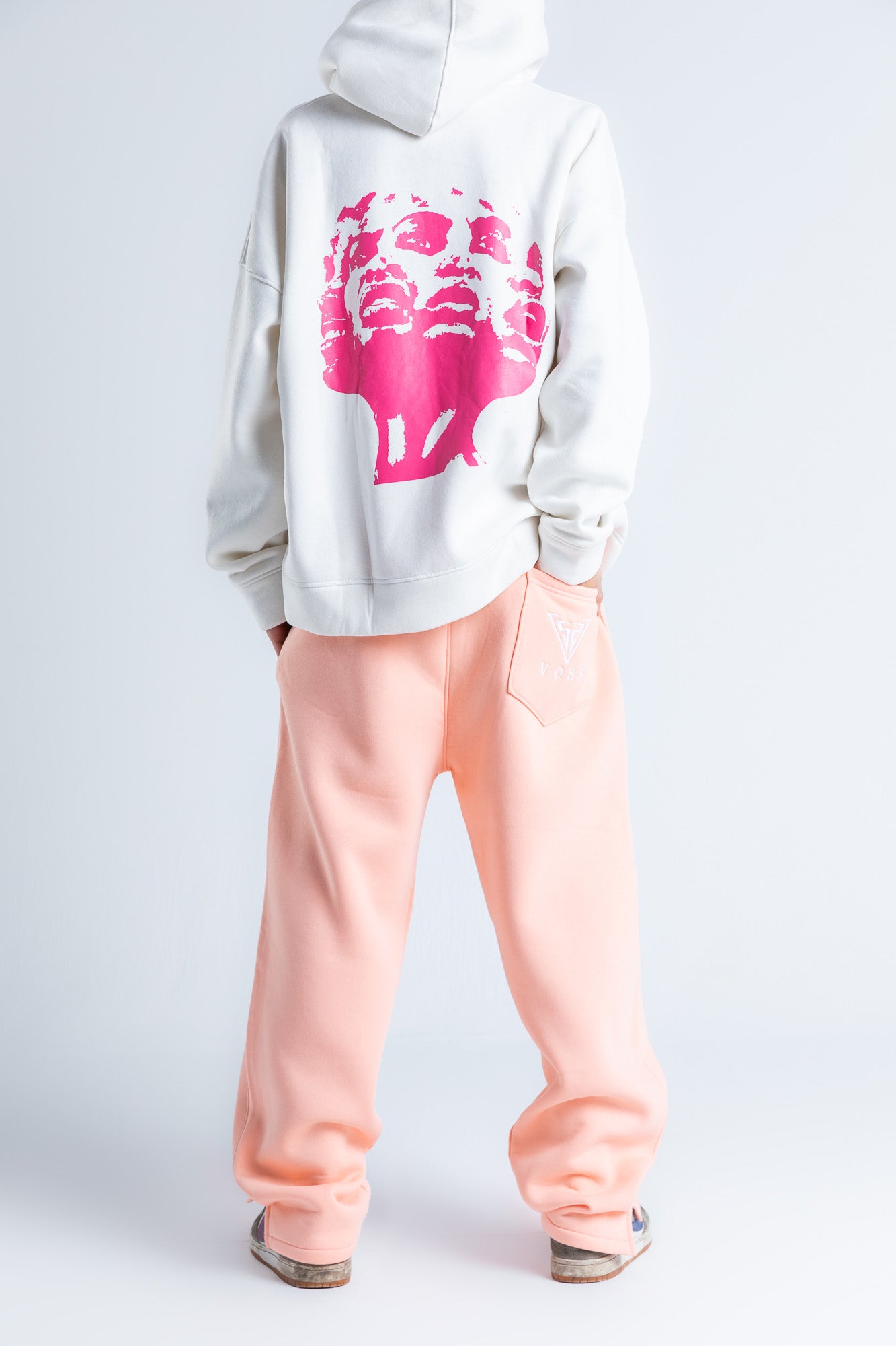 Back view of pink wide-legged sweatpants showcasing a seamless design with a comfortable, relaxed fit.