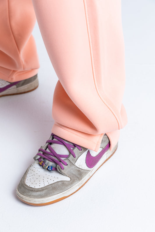 Pink wide-legged sweatpants styled with a casual outfit, ideal for lounging or running errands in comfort and style
