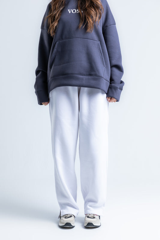 Front view of white wide-legged sweatpants featuring an elastic waistband, soft fabric, and a relaxed fit for casual wear.