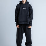 Black wide legged sweatpants with slim-fit design and adjustable waistband, front view.