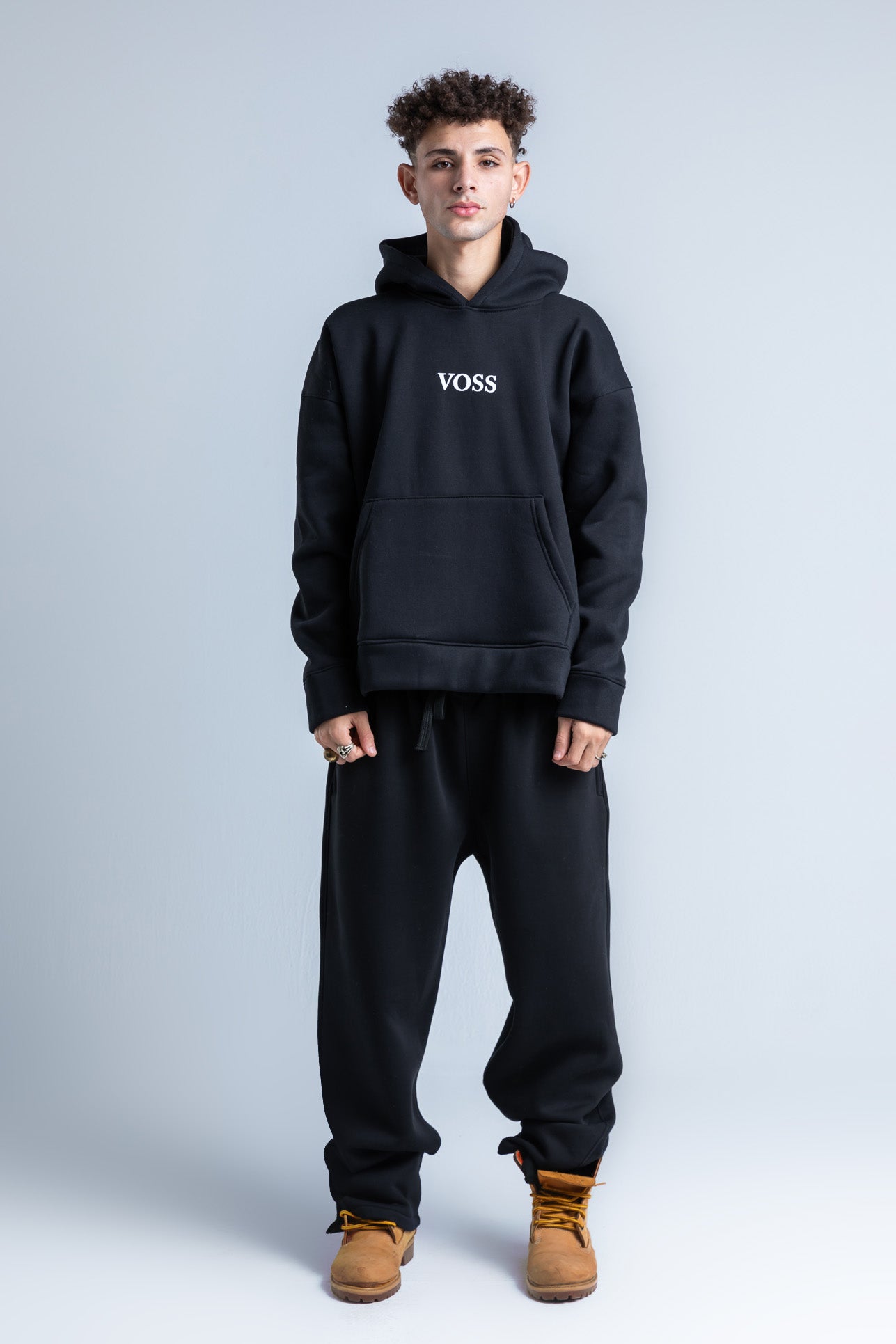 Black wide legged sweatpants with slim-fit design and adjustable waistband, front view.